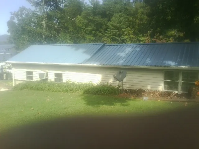 Blue metal roof running the length of a single story home in Staplehurst